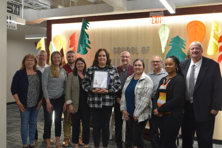 Rachel Bopp receiving award from colleagues