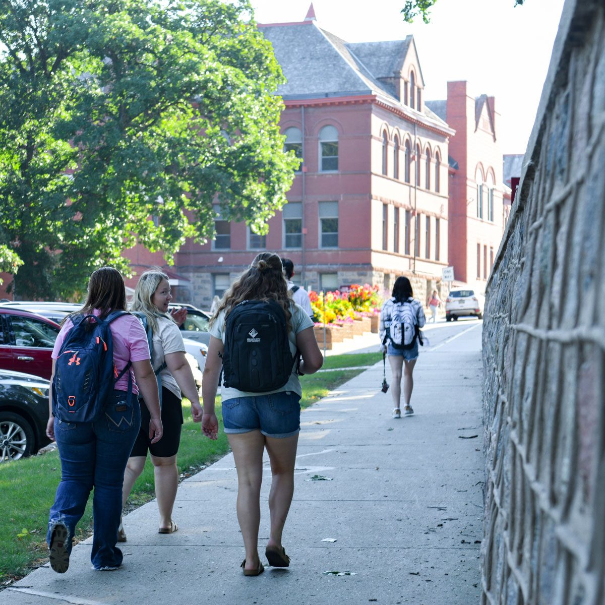 Three students walking to class on the campus of Valley City State University