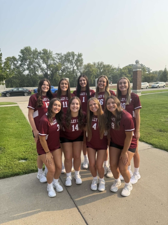 Hanna Wieland smiling at the camera alongside her female VCSU volleyball teammates 