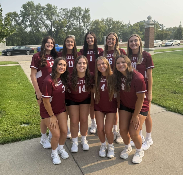 Hanna Wieland smiling at the camera alongside her female VCSU volleyball teammates