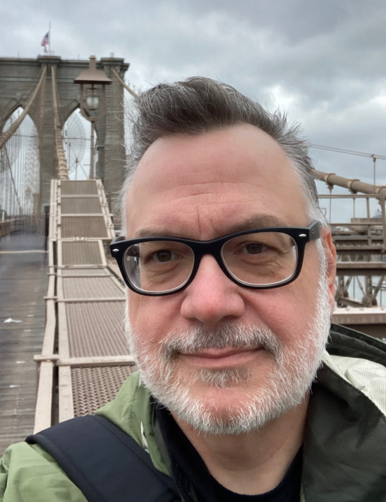 Brister posing in front of Brooklyn Bridge