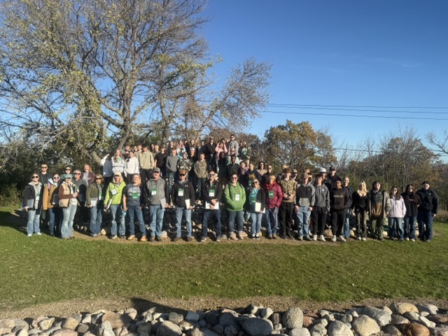 Large group of students smiling for camera at Medicine Wheel Park