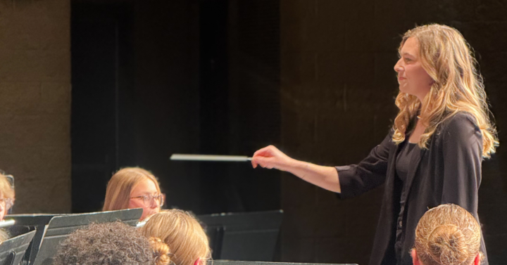 VCSU commencement speaker, Tara Dahl, conducting an orchestra