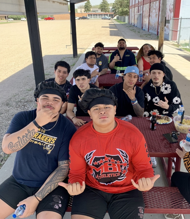 Students sitting at picnic tables