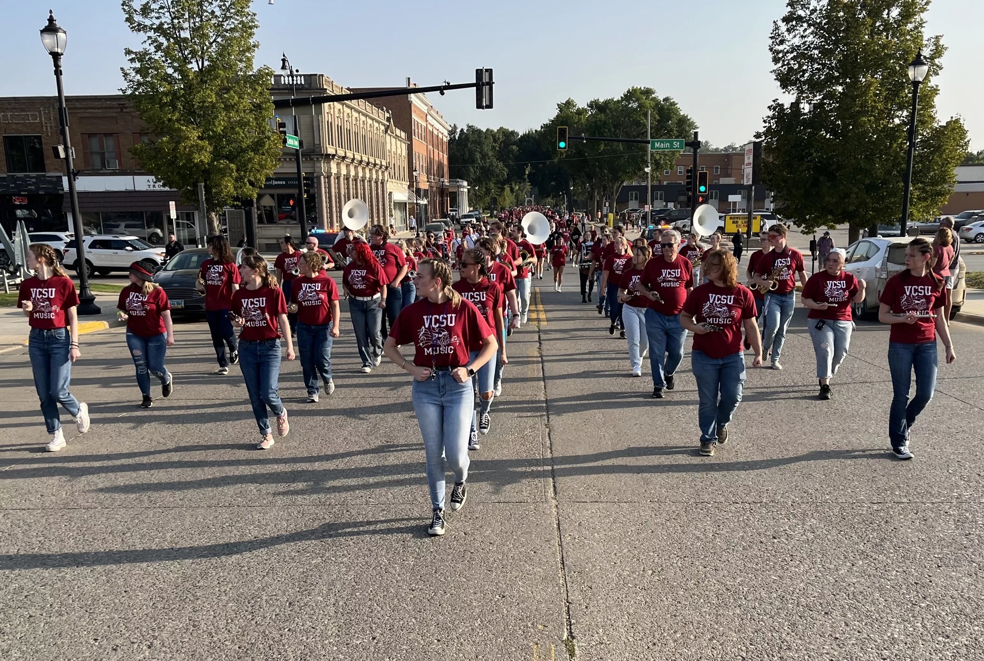 Tara Dahl leading band, walking down the street