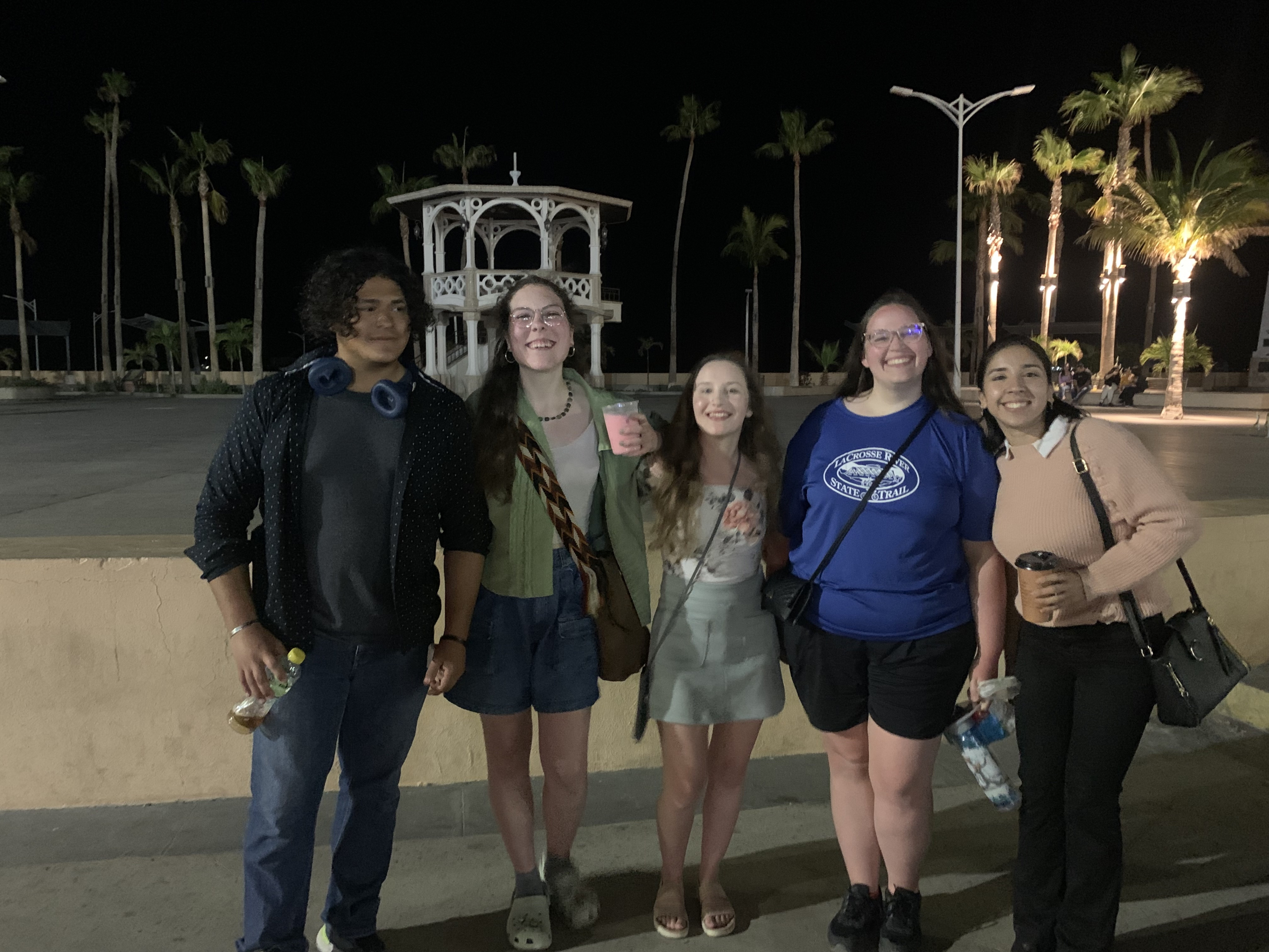 Students pose for a photo during evening on a street