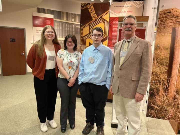 Grace Reep and Preston Halverson pictured with professor Steven King and another student at the conference