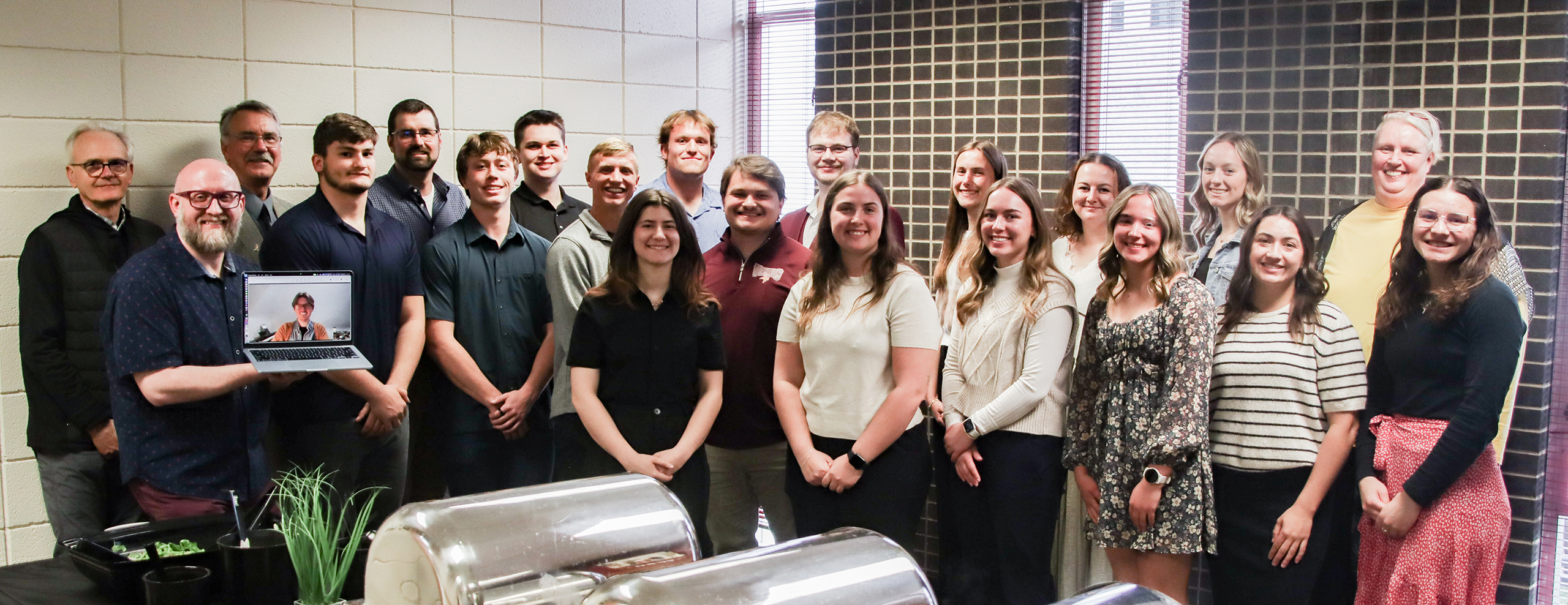group of students and mentors smiling at camera