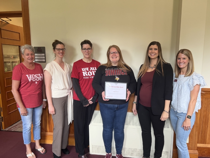 Bridget Blunck receiving award from colleagues