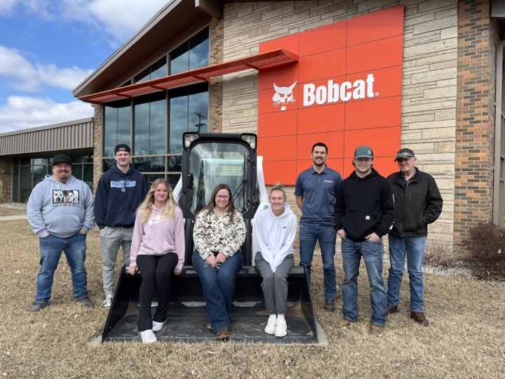 Students posing in front of Bobcat