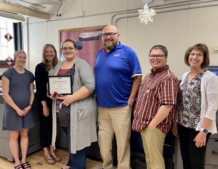 Aleisha Kiser receiving award from enrollment services