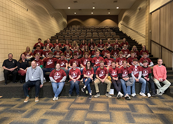 Lisbon High School dual-credit students sit in a theat while wearing VCSU shirts
