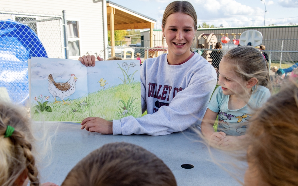 Mathea reading to a group of young children 