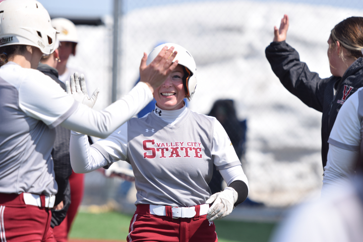 softball player receiving high fives