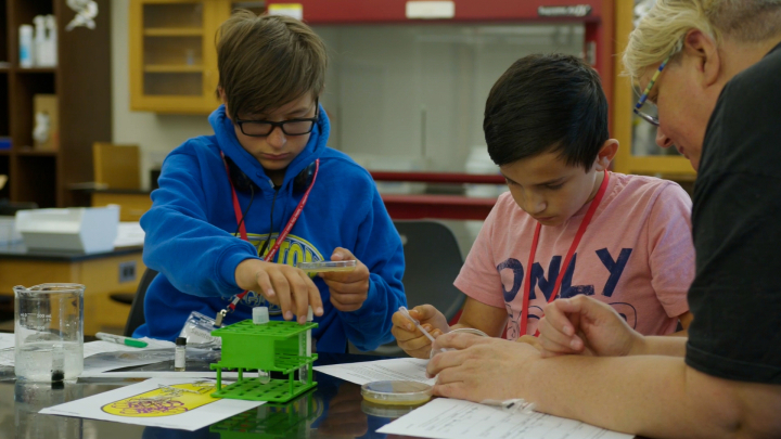 Students working with an instructor at INSTEM academy