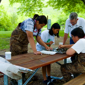 Students working with an instructor at INSTEM academy