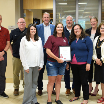 Staff member of the quarter Melinda Schwab of buildling services receives her award.