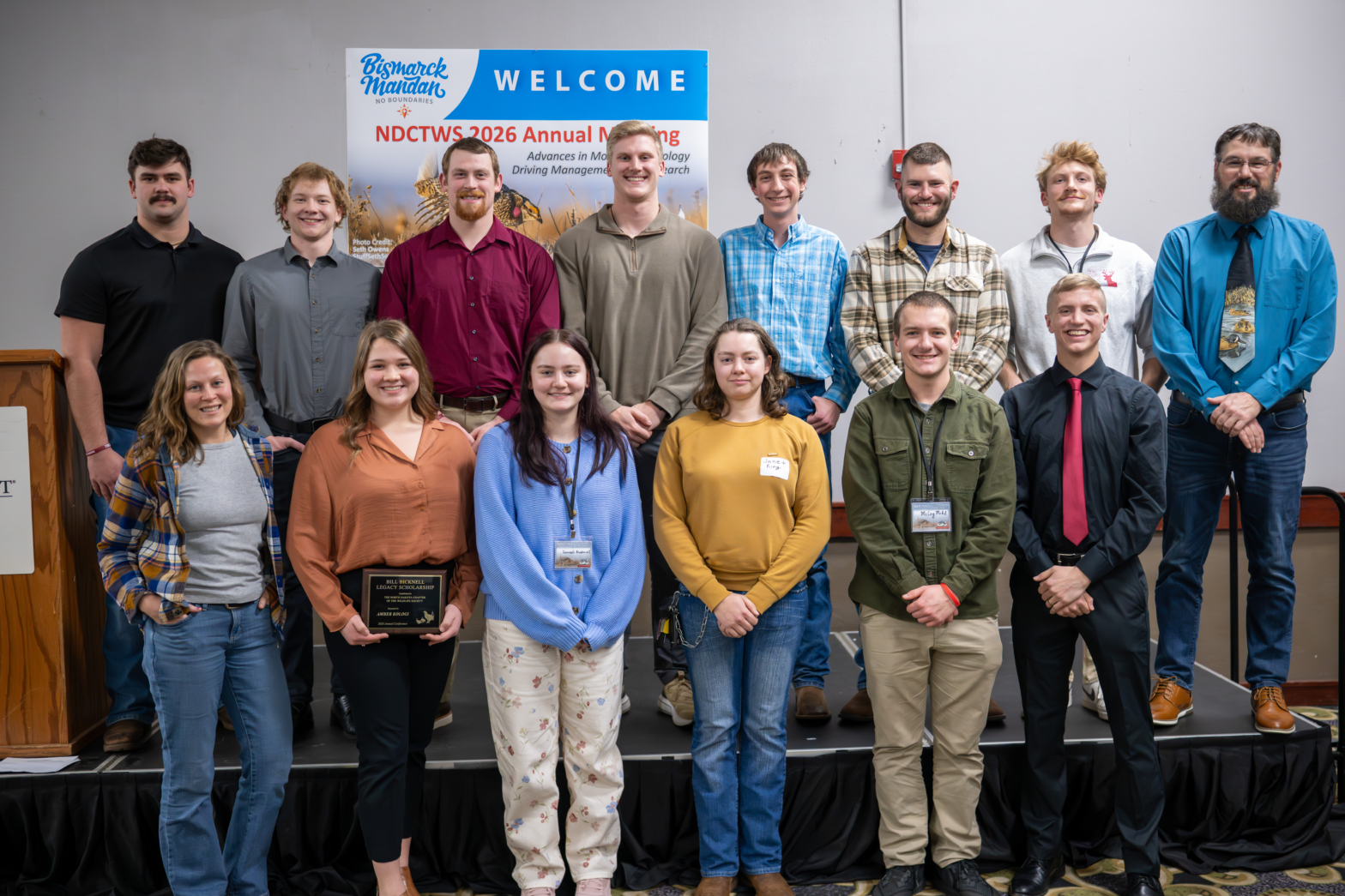 Students and faculty posing for photo at conference