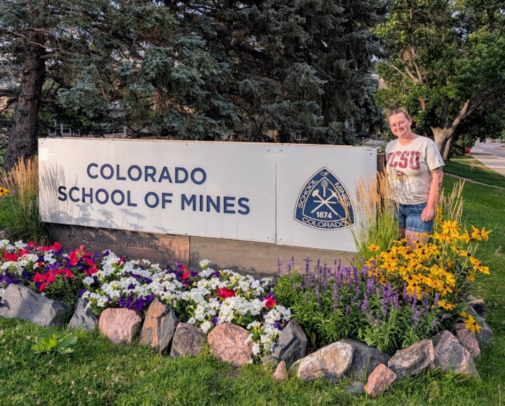 Lindsey Kiecker standing by Colorado School of Mines sign