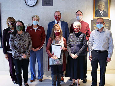 Paula Larson receiving award from cabinet members