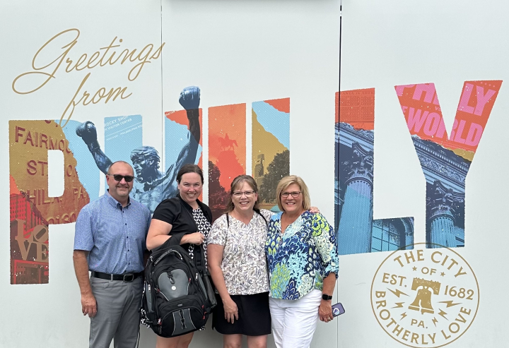 segs faculty posing in front of Philly sign