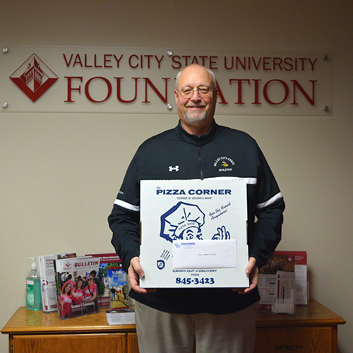 Steve Olson holding Pizza Corner pizza box