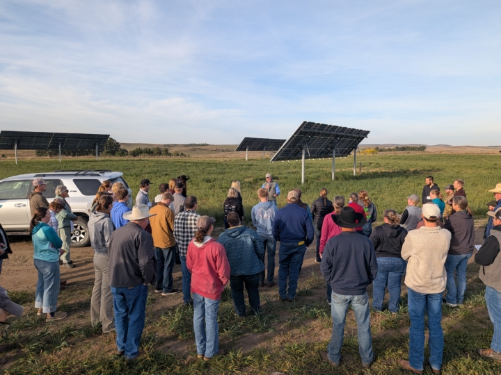 conference participants outside near solar energy site