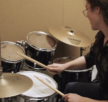 Female student playing drums