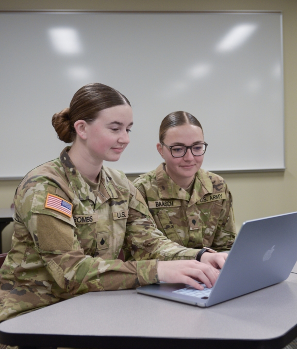 Photo of Jaydin Rombs and female guard student working on laptop