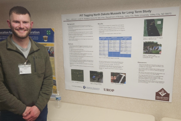 Tyler standing with his presentation