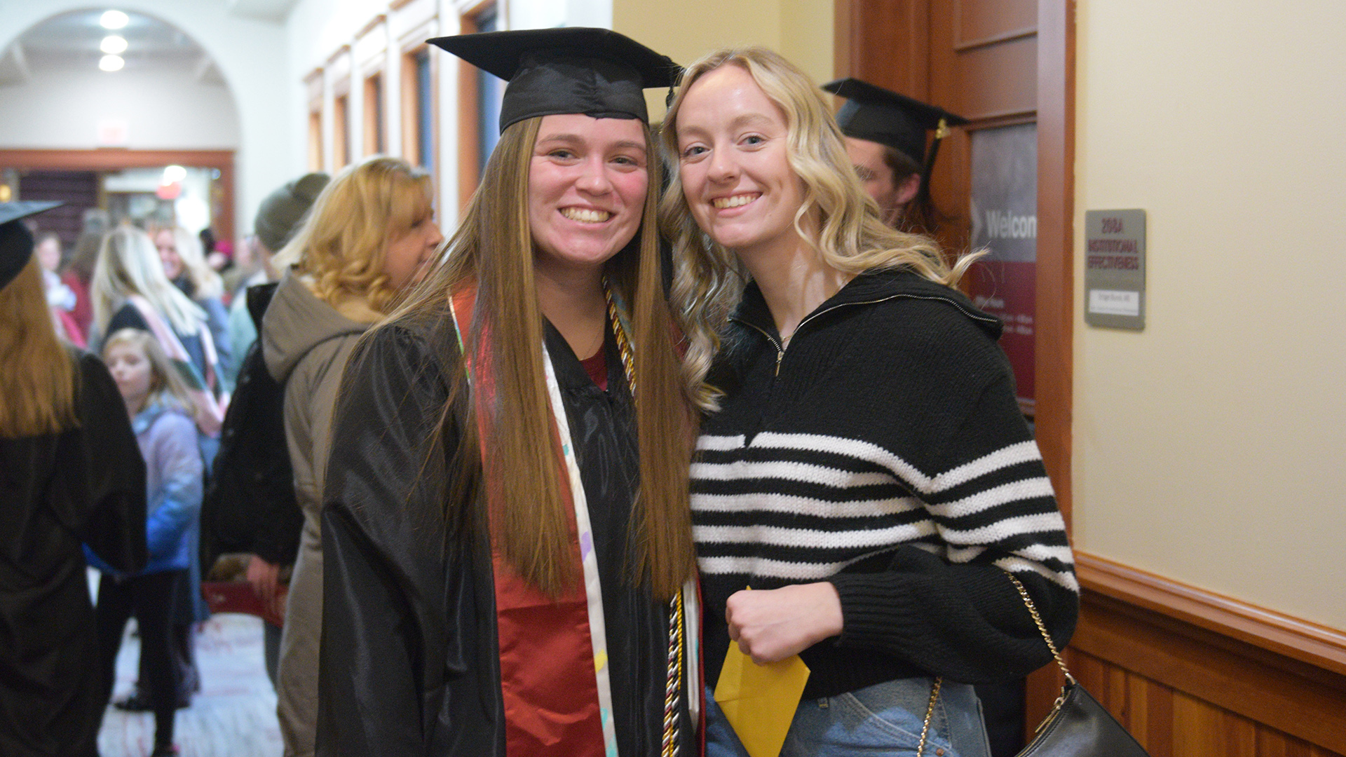 A graduate and her friends smile together for a photo
