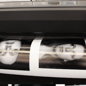 Images on a screen being printed on photo paper