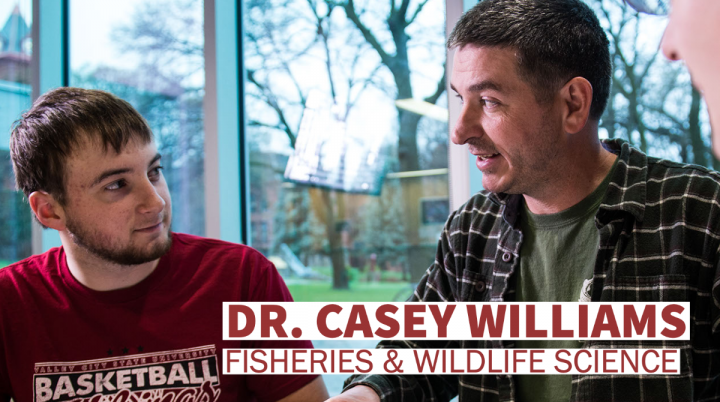 Dr. Casey Williams talking to student