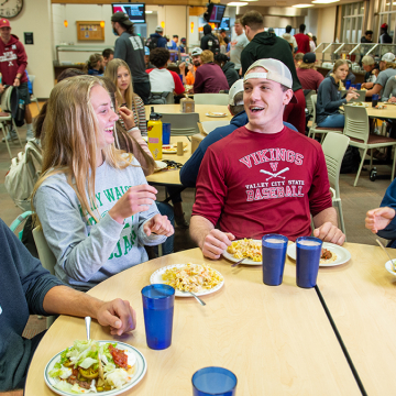 students laughing at lunch in the cafeteria