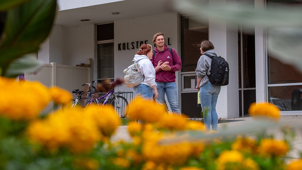 Students standing outside of dorm hall