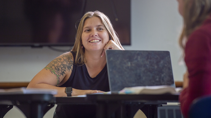 Female student smiling at another classmate