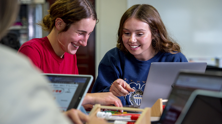 Two female students working on a project together