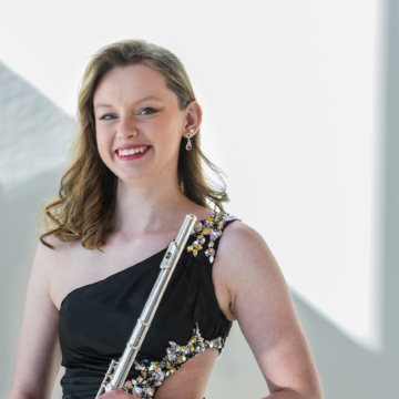 Alexis Busch holding flute while smiling