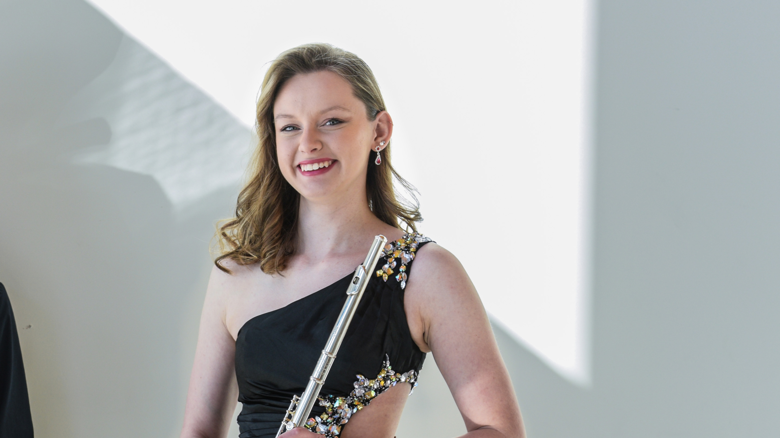 Alexis Busch holding flute while smiling