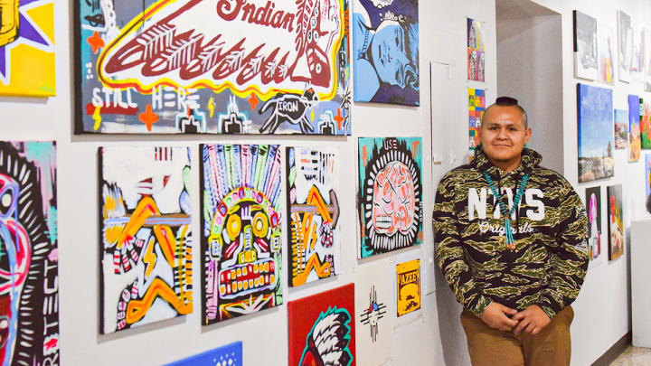 VCSU student displaying artwork at exhibition