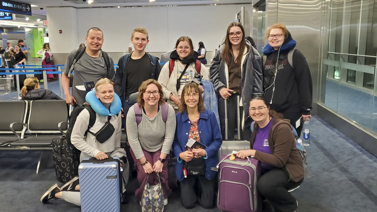 group posing at airport