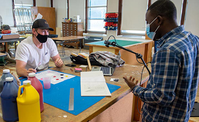 student and professor in art class