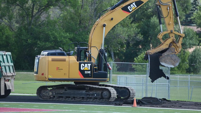 A construction crew removes the old track surface at Lokken Stadium on Thursday, June 28.