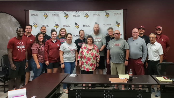 Ethan Bakken with athletics staff