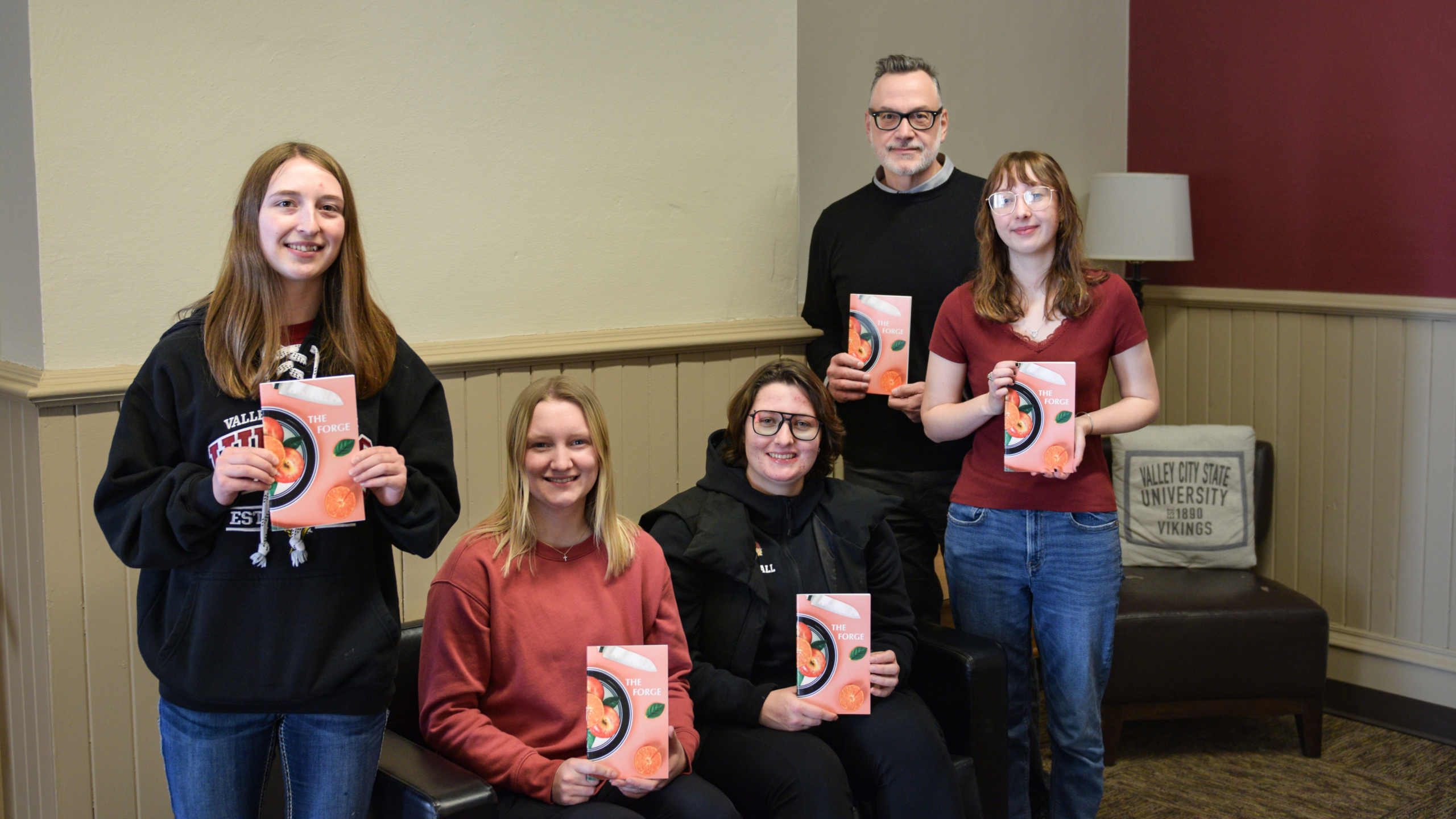 Forge editors holding copies of the publication