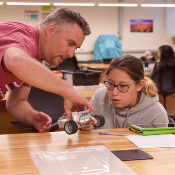 Student and instructor collaborating during a STEM workshop