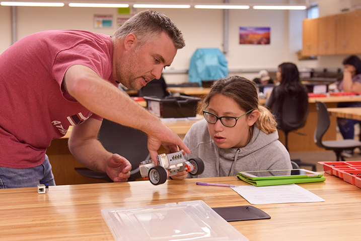 Student and instructor collaborating during a STEM workshop