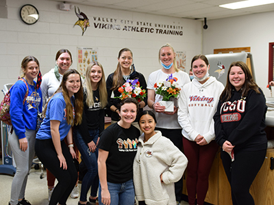 Athletic training staff with students