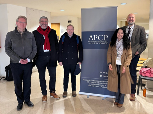 Anthony Dutton and others posing in front of APCP banner