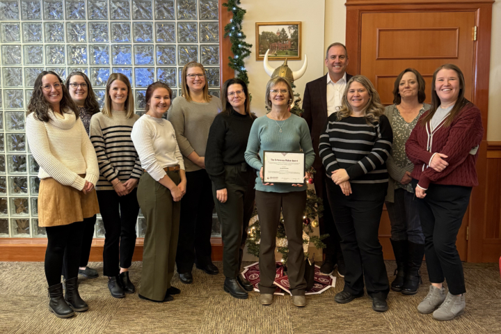 Janet Gierke receiving award from colleagues